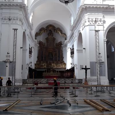 Montaggio palco in chiesa storica per evento culturale con tralicci e strutture scenotecniche