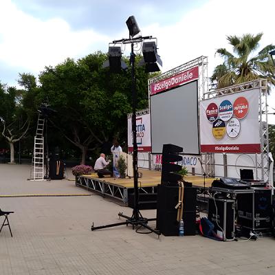Palco all’aperto per comizio politico con impianti audio e videoproiezione